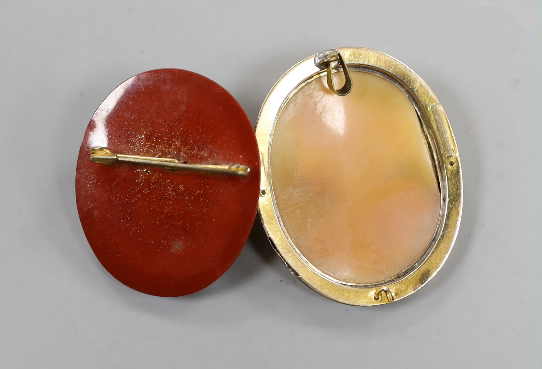 Two cameo brooches including yellow metal mounted cameo shell, carved with the bust of a lady to sinister, 50mm.